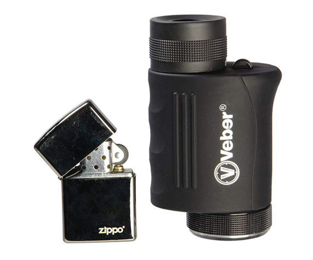 Зажигалка на фоне монокуляра Veber 8-20x25