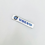Наклейка Volvo с лого объемная полиурентан (шильдик Вольво, 12х2,5см). Серебристая с синей надписью и лого