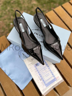 Women's Prada lux class shoes with a small curly heel, with a pointed toe and an open heel. The uniqueness of the model lies in the heel itself in the form of a comma and an unusual sole borrowed from sneakers. The model is made of genuine black leather.