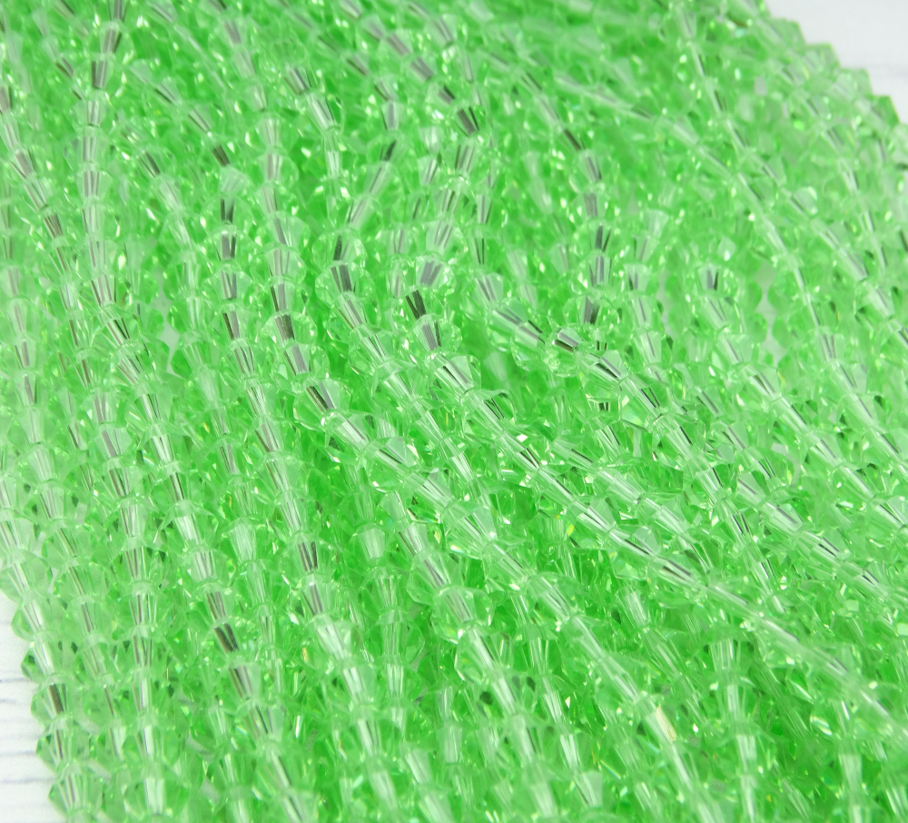 ББ020НН4 Хрустальные бусины "биконус", цвет: св-зеленый прозрачный, размер 4 мм, кол-во: 95-100 шт.