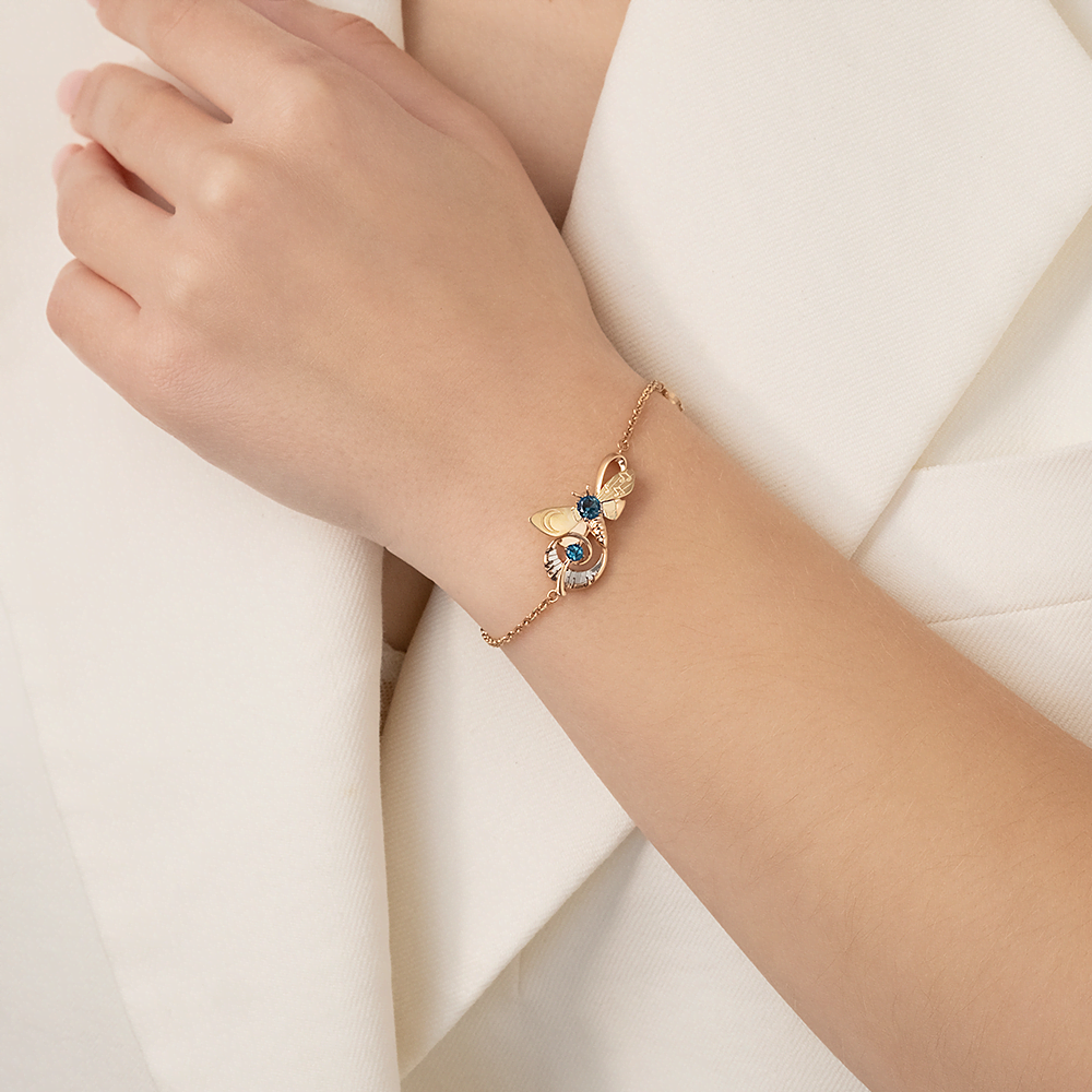 Браслет «Мелодия ночи» из комбинированного золота с топазами