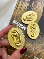 Пуговицы Скиапар. овальные рельефные матовое золото с дизайном "Ухо"