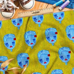 Ткань атлас синие кукольные головы на жёлтом фоне