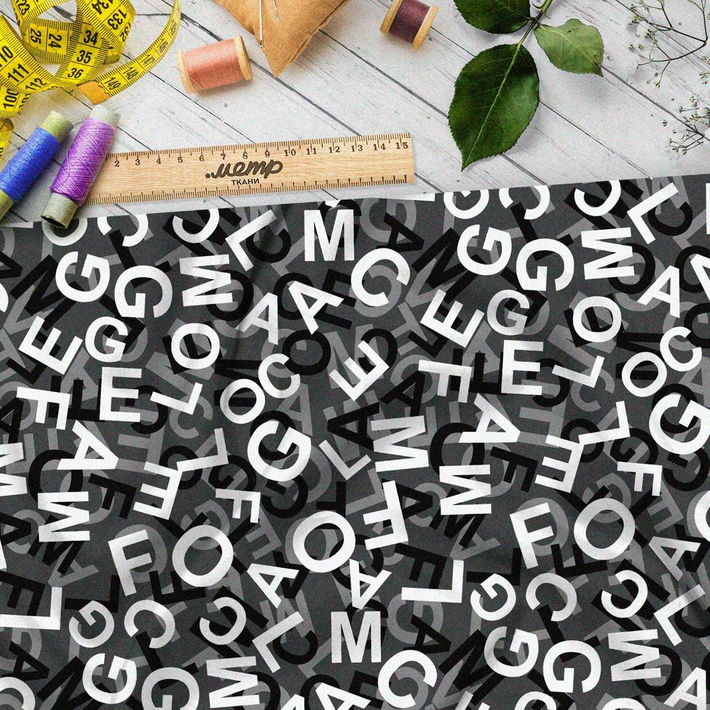 Ткань футер 2-х нитка хаос их букв на чёрном фоне