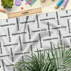 Ткань барби стильная клетка из чёрных надписей на бежевом фоне