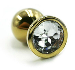 Золотистая алюминиевая анальная пробка с прозрачным кристаллом - 7 см. (Цвет: прозрачный)