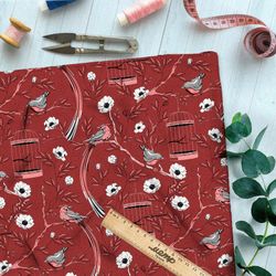 Ткань ниагара мелкие снегири, цветы и птичьи клетки на бордовом фоне