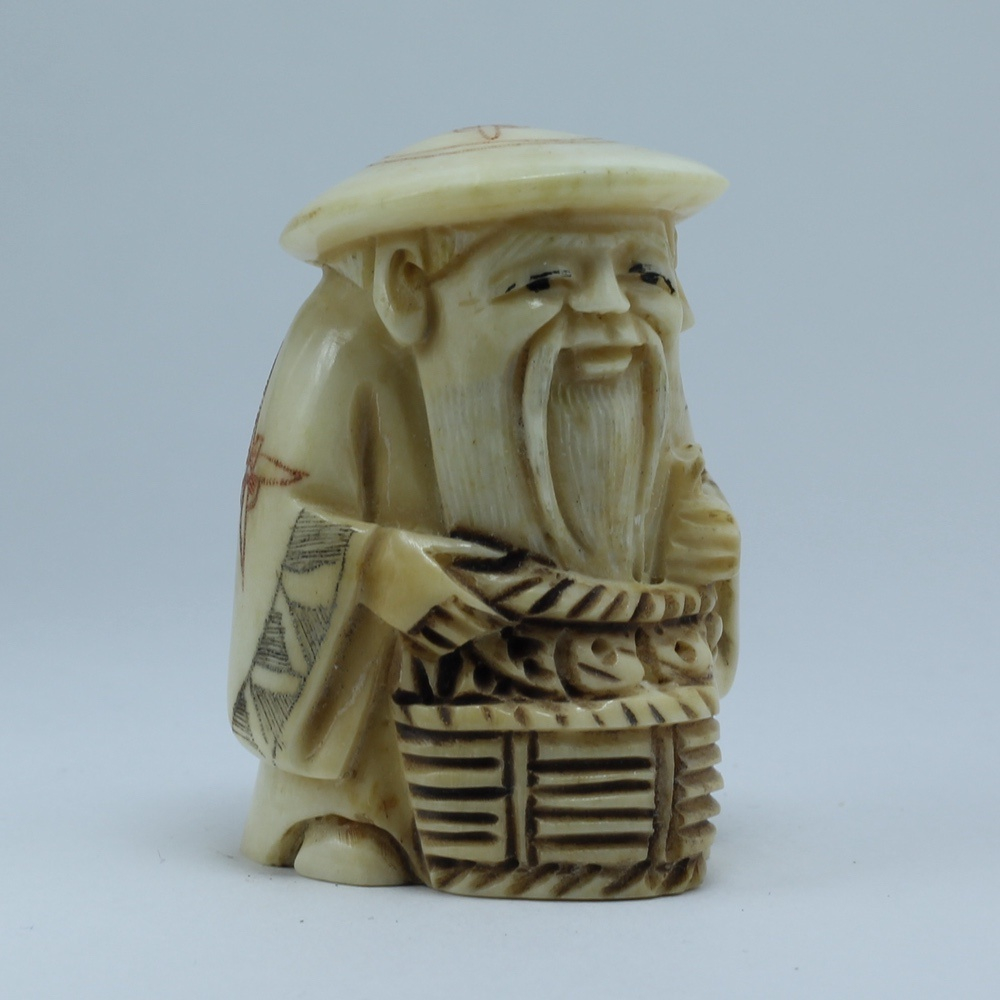 Нэцкэ Дзюроднин в круглой шапке с корзиной рыбы