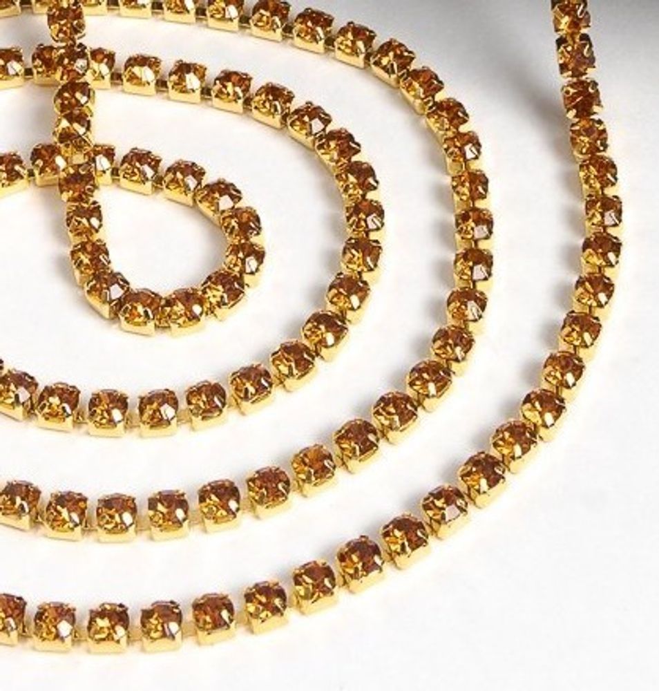 Цепь со стразами, ss16, ш. 4 мм, тёмное золото в золотой оправе