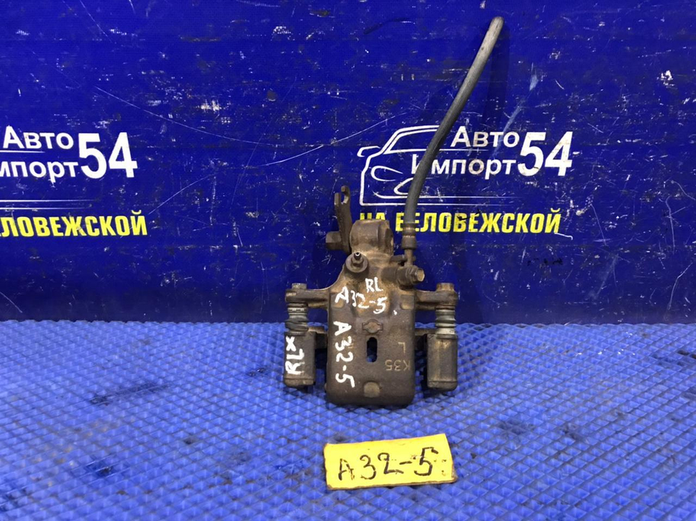 Суппорт тормозной задний левый NISSAN CEFIRO 1997