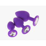 Анальная пробка из фиолетового силикона с тёмно-зелёным кристаллом (размер S)