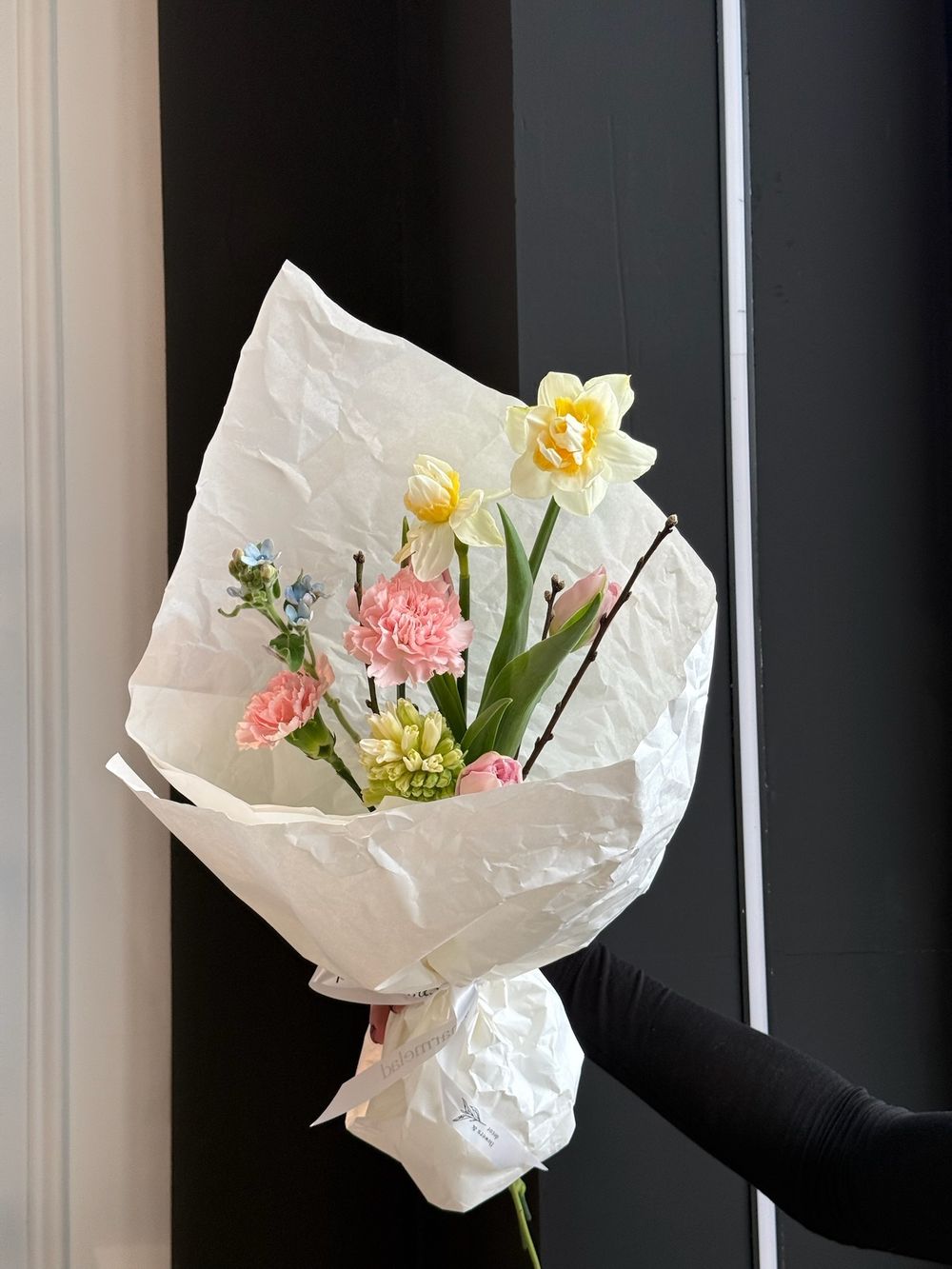 Букет из нарциссов, диантусов, гиацинта, окиспеталума и веток прунуса