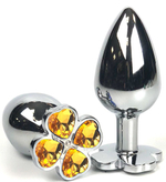 Серебристая анальная втулка с клевером из оранжевых кристаллов - 9 см. (Цвет: оранжевый)