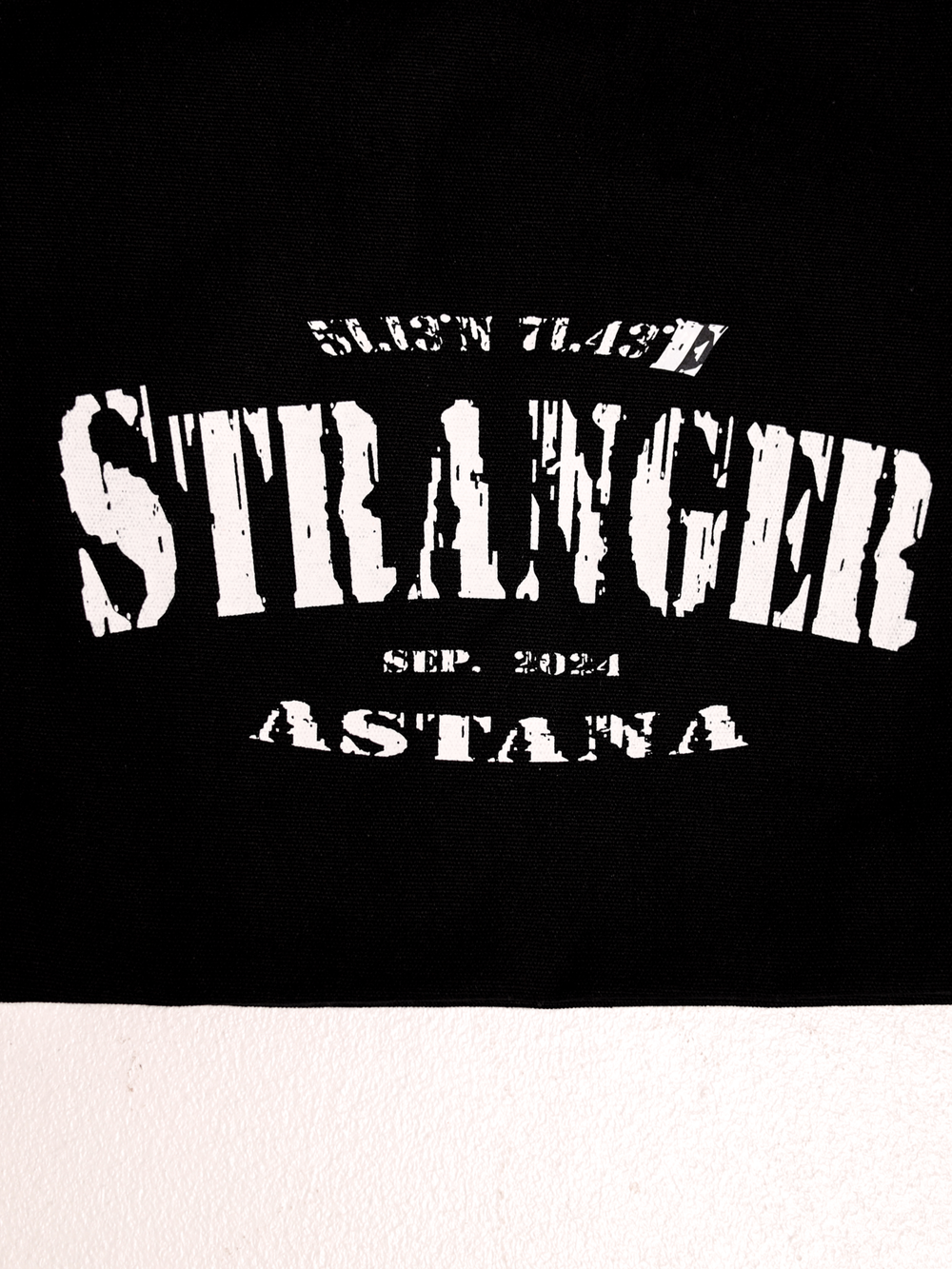Shopper with "Stranger" logo