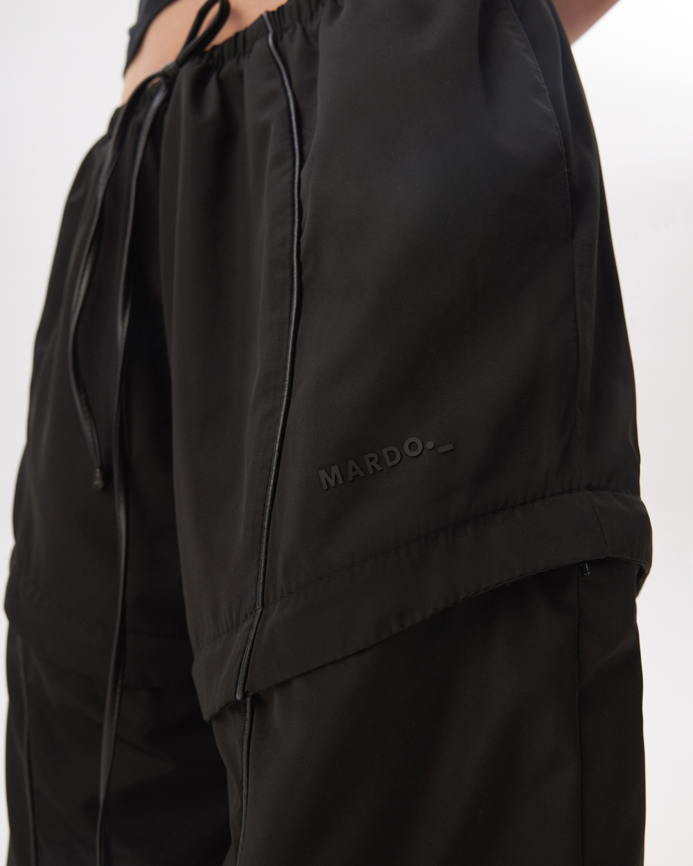 BLACK TRANSFORMING TRACKPANTS