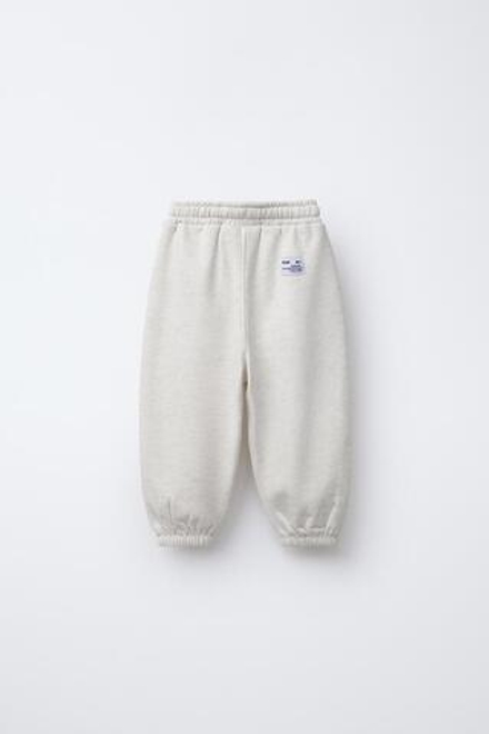 ZARA ДЖОГГЕРЫ ИЗ МЯГКОЙ ТКАНИ С НАДПИСЬЮ, БЕЖЕВЫЙ С МЕЛАНЖЕВЫМ ЭФФЕКТОМ