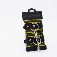 Черно-желтые кожаные наручники с жёлтой строчкой
