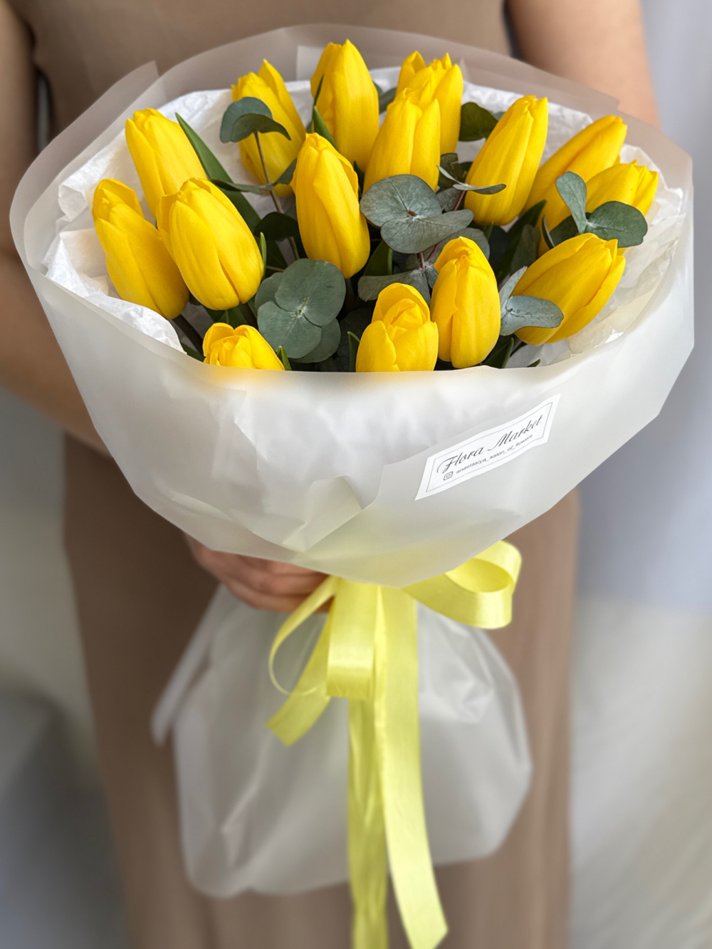Яркие желтые тюльпаны премиум сорта и зелень эвкалипта в воздушном оформлении от Флора Маркет