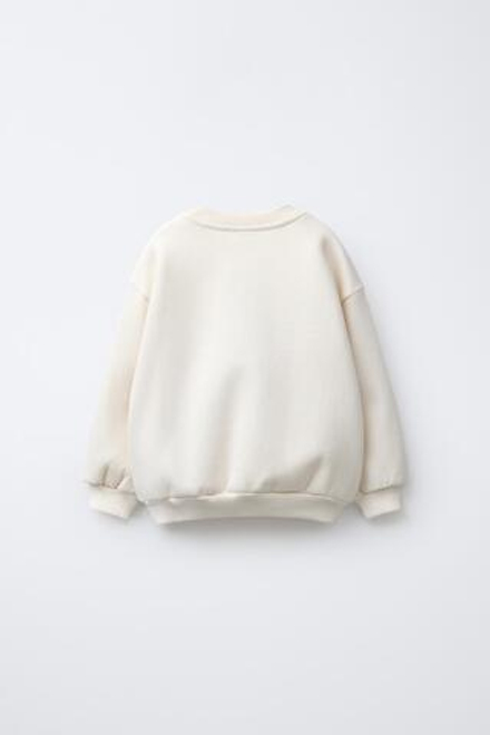 ZARA ТОЛСТОВКА С ВЫШИВКОЙ BUDDY TOY STORY © DISNEY PIXAR, ЭКРЮ