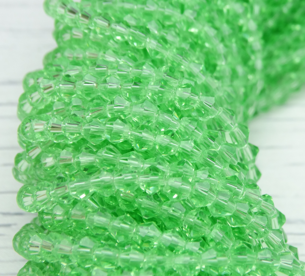ББ020НН3 Хрустальные бусины "биконус", цвет: св-зеленый прозрачный, размер 3 мм, кол-во: 95-100 шт.