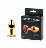 Золотистая анальная пробка с малиновым кристаллом-сердечком - 7 см. (Цвет: малиновый)