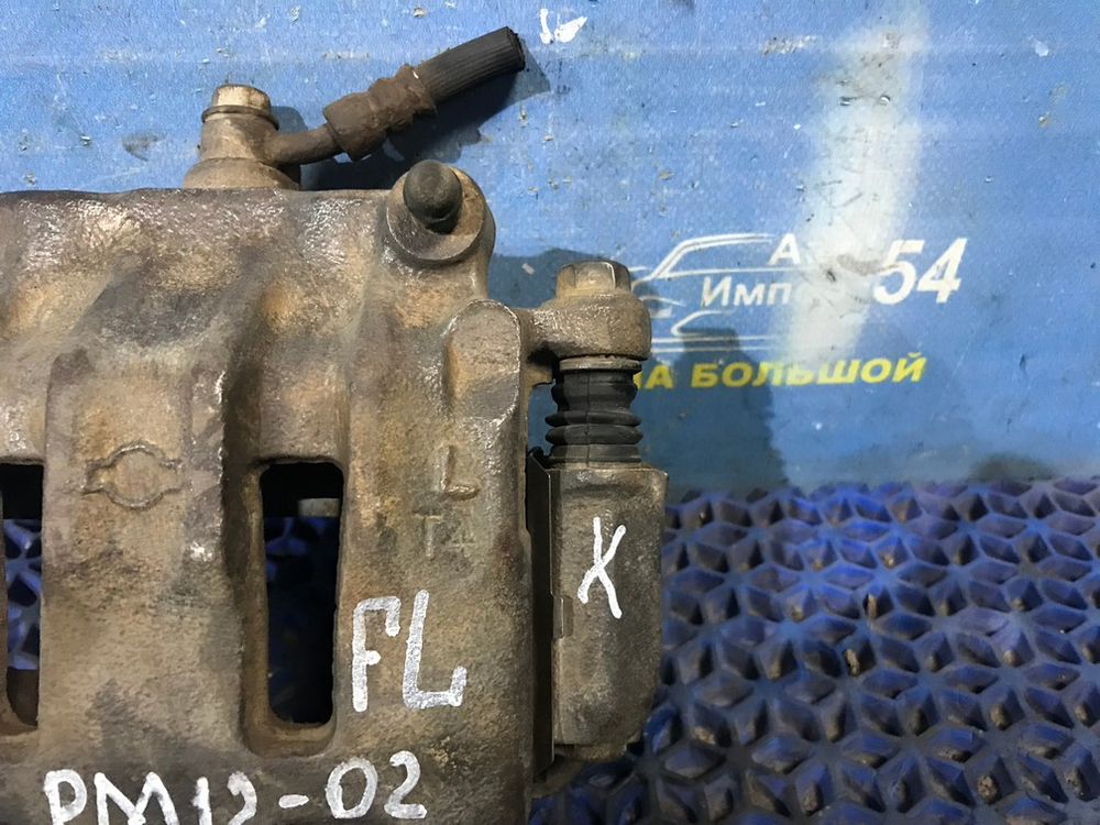 Суппорт тормозной передний левый NISSAN LIBERTY 1999