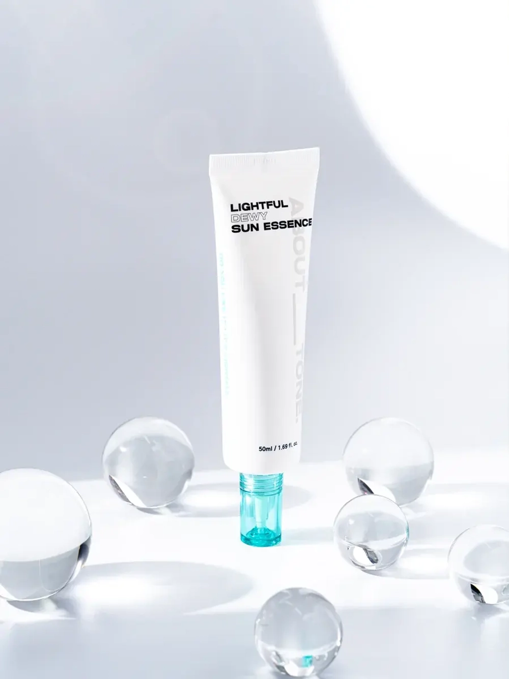 About Tone Легкий увлажняющий солнцезащитный флюид SPF50 Lightful Dewy Sun Essence 50 мл