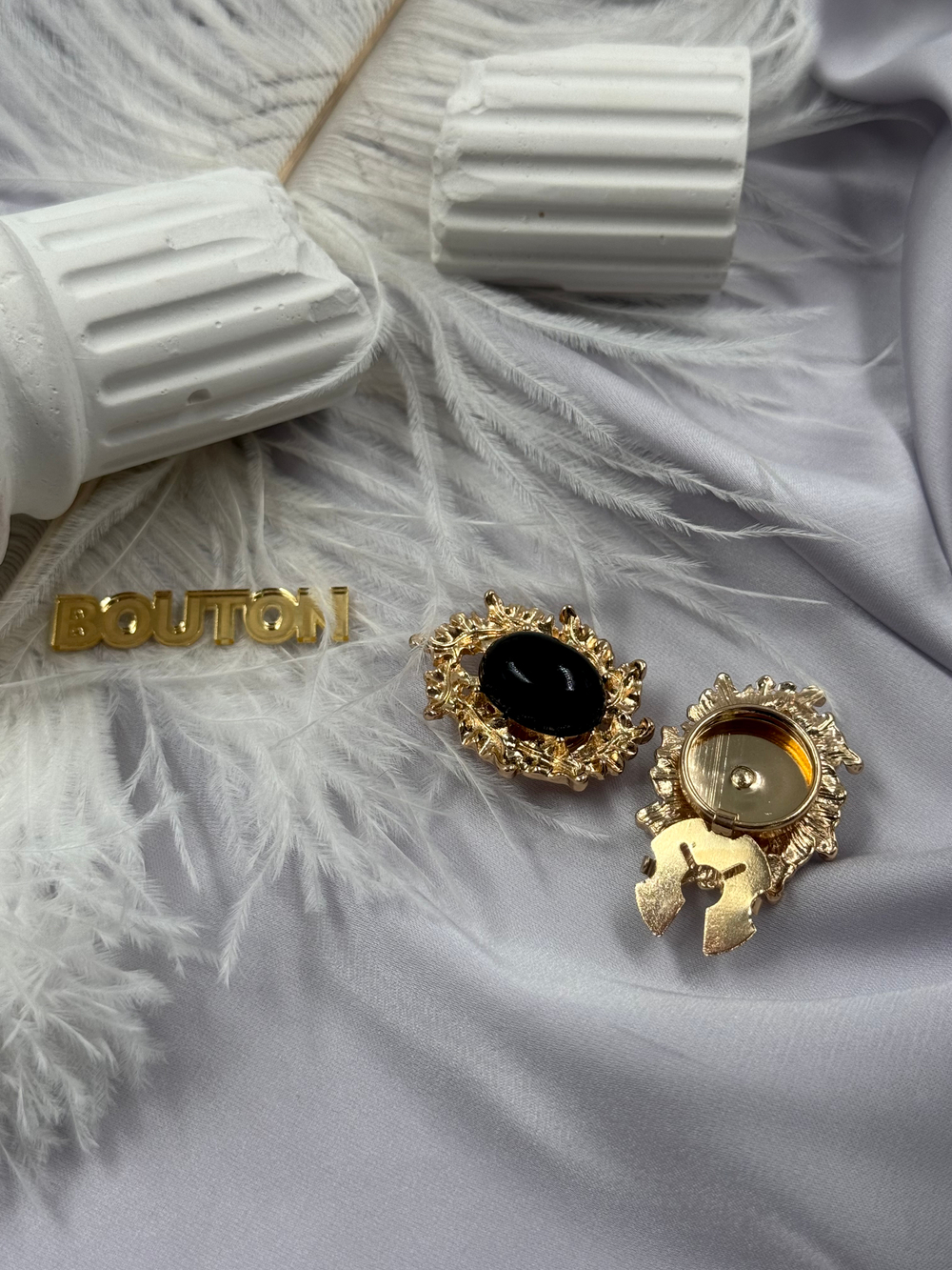 Накладка на пуговицу золотистая с ажурным (неровным) краем и черным камнем