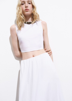 Укороченный топ с бантом на спине