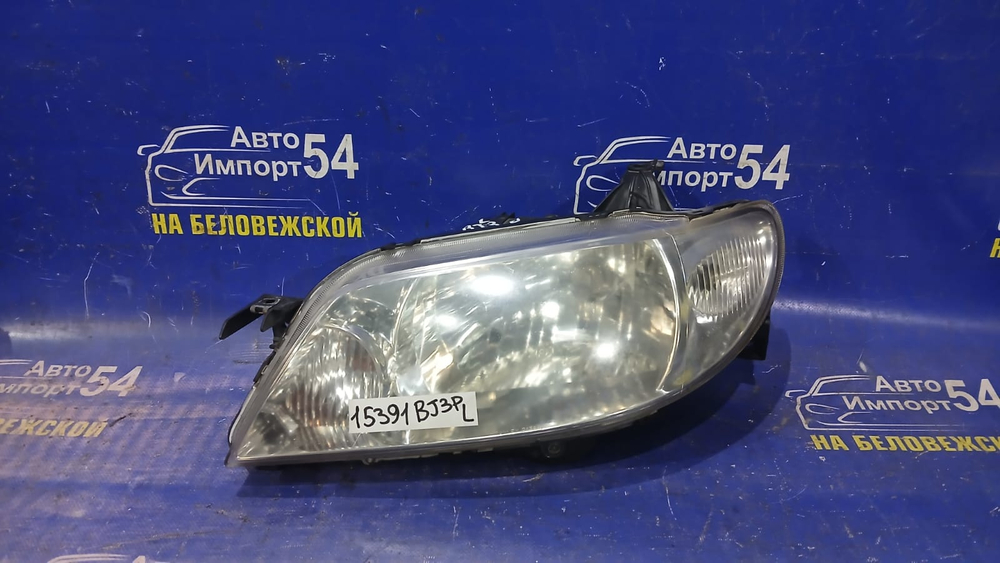 Фара передняя левая MAZDA FAMILIA 2000-2003
