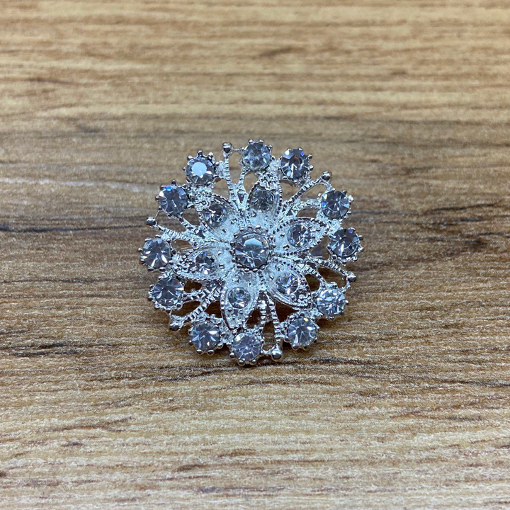 Брошь Elegant mini Круг шестилистник заостренный стразы металл серебристый