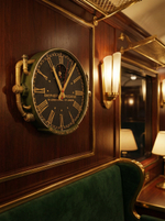 Настенные часы Oriental Express WOODandROOT в интерьере поезда, классические панели и мягкий вечерний свет