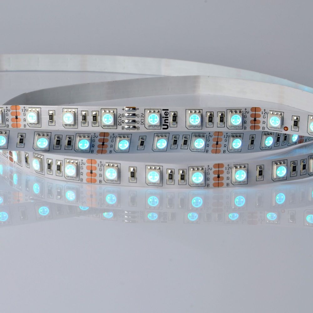 ULS-5050-60LED-m-10mm-IP20-DC24V-14.4W-m-5M-RGB Гибкая светодиодная лента UNIEL на самоклеящейся основе. Упаковка катушка 5 м. в герметичной упаковке. IP20. Угол излучения 120 . Мультиколор.