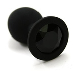 Чёрная силиконовая анальная пробка с чёрным кристаллом - 7 см.