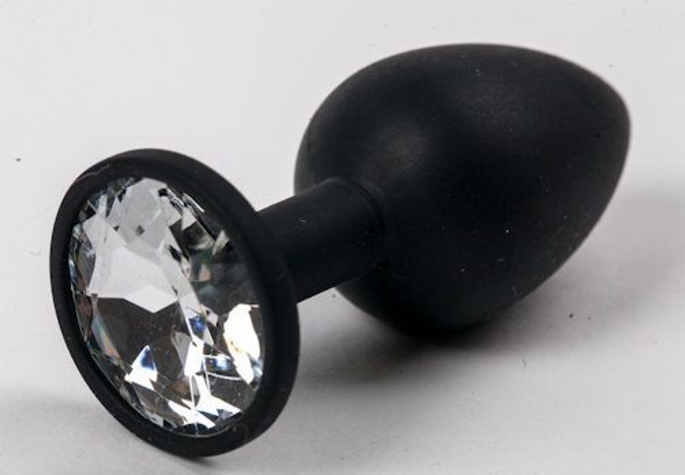 Черная силиконовая анальная пробка с прозрачным стразом - 7,1 см. (Цвет: прозрачный)