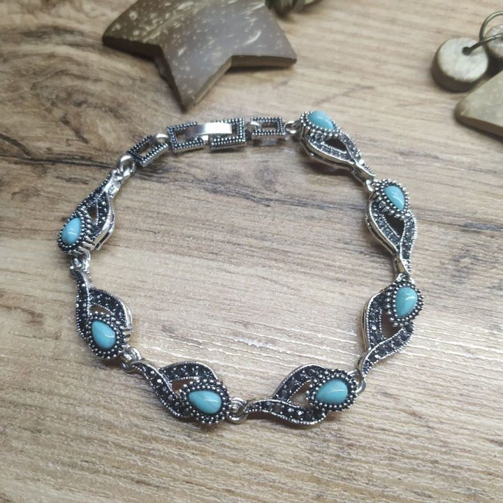 Браслет Vogue Тюльпан бусина под бирюзу стразы графитовые металл серебристый на красном бархате