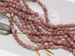 Нить бусин из родонита 7х9мм (галтовка)