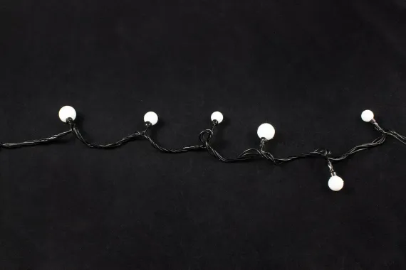 Светодиодная нить шарики 10 м., 220V, 100 теплых белых LED ламп, диаметр шариков 2*1,6*1*1,4 см., черный провод, Winner Light (ww.01.5В.100+Mixball)