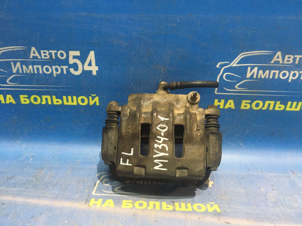 Суппорт тормозной передний левый NISSAN CEDRIC 2000