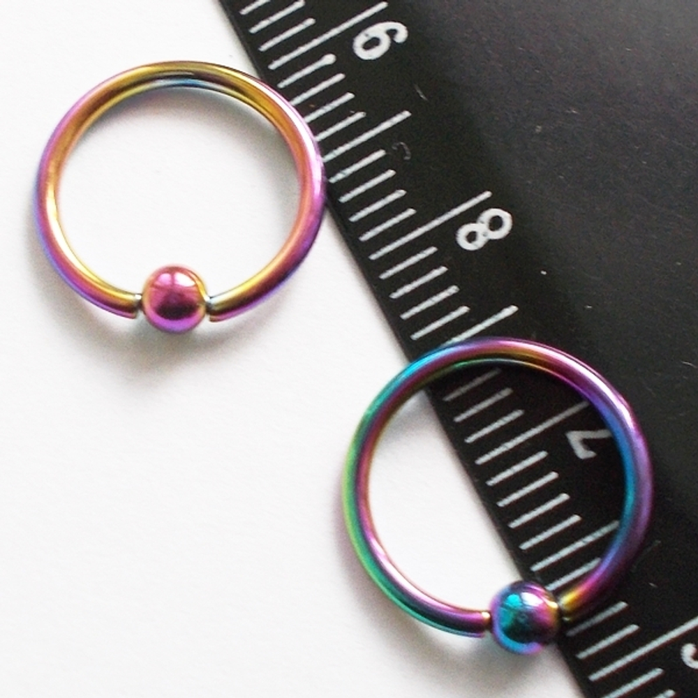 Кольцо сегментное 1,2мм (бензинка), диаметр 10 мм, шарик 3 мм для пирсинга. Медицинская сталь, покрытие титан.