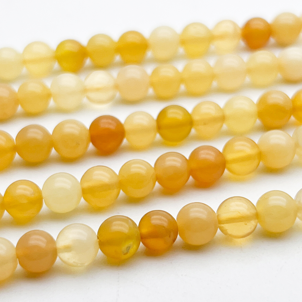 Опал желтый бусины, диаметр 5,6-5,9 мм, цена за 33-34 шт (1/2 нити)