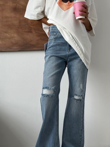 Синие рваные джинсы-клеш