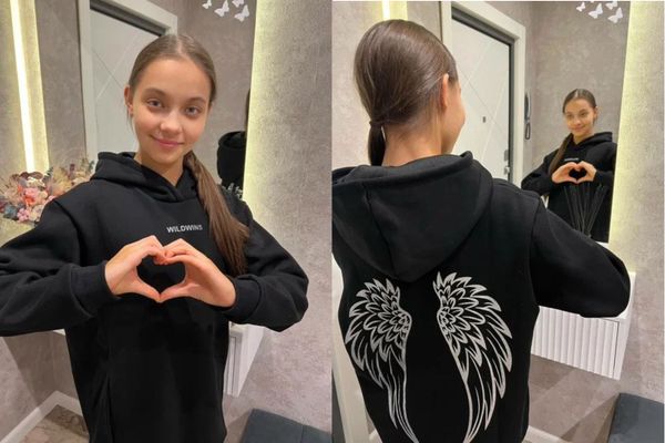 Сабина в черном худи с крыльями