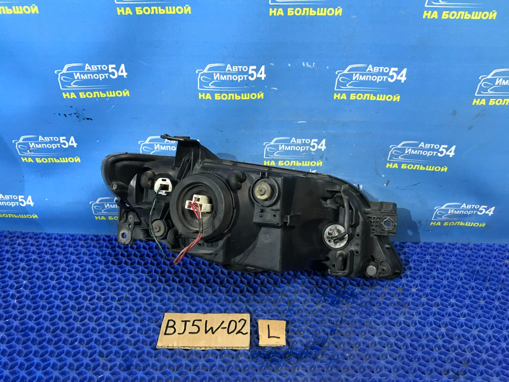 Фара передняя левая MAZDA FAMILIA 2001