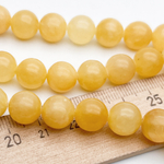 Кальцит желтый бусины, диаметр около 10,3-10,7 мм, цена за 18-19 шт (1/2 нити)