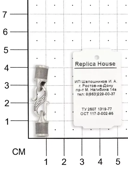 Фото замок для гайтана под шнур 5 мм из серебра, вид на размерной сетке.