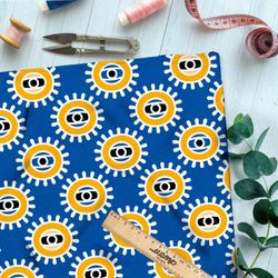 Ткань бифлекс солнечные глаза на голубом фоне