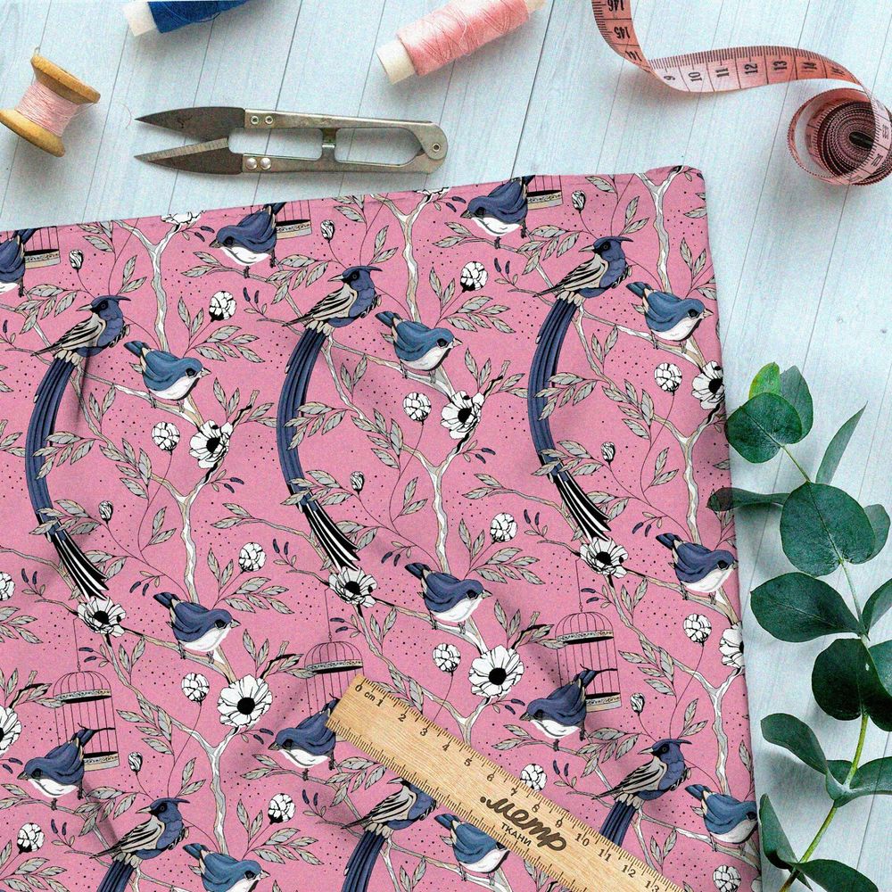 Ткань интерлок мелкие снегири, цветы и птичьи клетки на розовом фоне