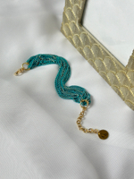 Браслет нити "шелк" бирюзового оттенка с золотым отливом