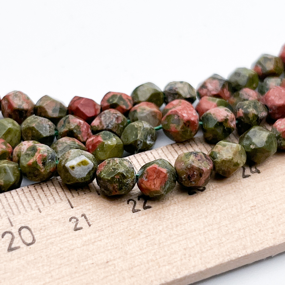 Унакит крупной огранки бусины, размер около 5,9-6,2 мм, цена за 27-28 шт (1/2 нити)